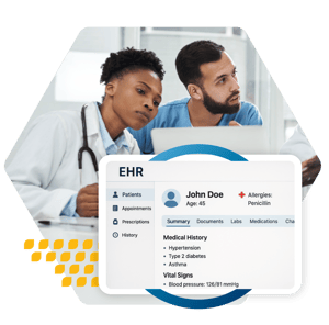 Two healthcare providers reviewing medical history of a patient